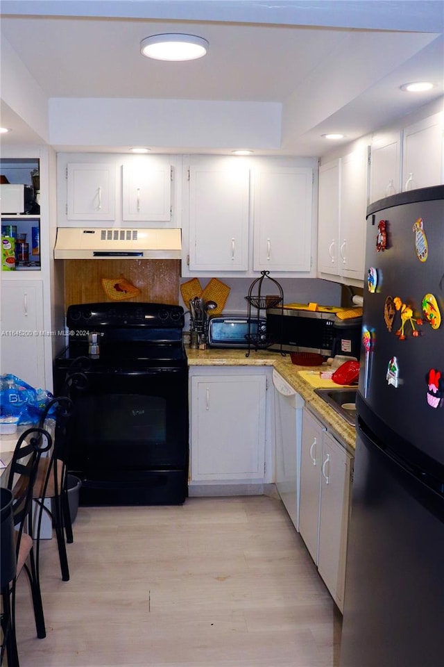 900 Saint Charles Pl Unit 316, Pembroke Pines, FL 33026 - kitchen featuring black appliances, range hood, white cabinets, and light wood-style flooring