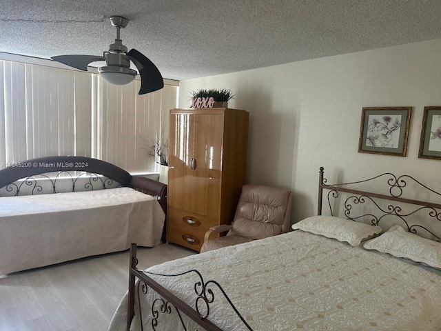 900 Saint Charles Pl Unit 316, Pembroke Pines, FL 33026 - bedroom with wood finished floors, a ceiling fan, and a textured ceiling