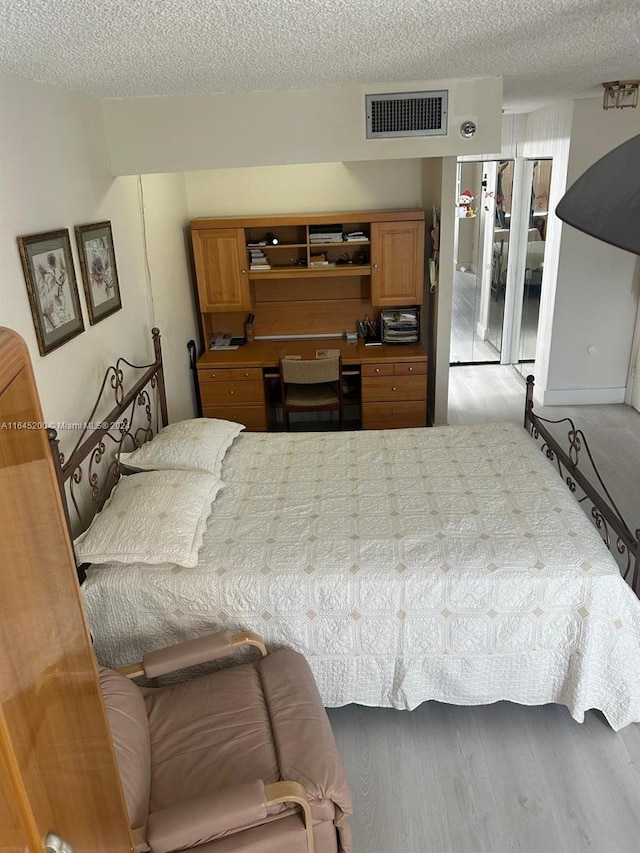 900 Saint Charles Pl Unit 316, Pembroke Pines, FL 33026 - bedroom with a textured ceiling and wood finished floors