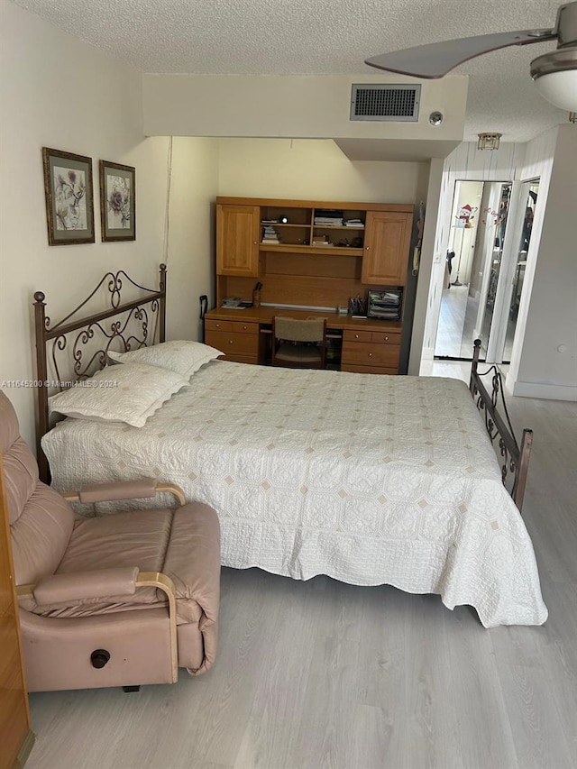 900 Saint Charles Pl Unit 316, Pembroke Pines, FL 33026 - bedroom with wood finished floors and a textured ceiling