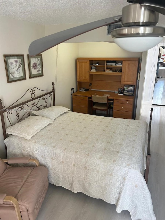900 Saint Charles Pl Unit 316, Pembroke Pines, FL 33026 - bedroom with wood finished floors and a textured ceiling