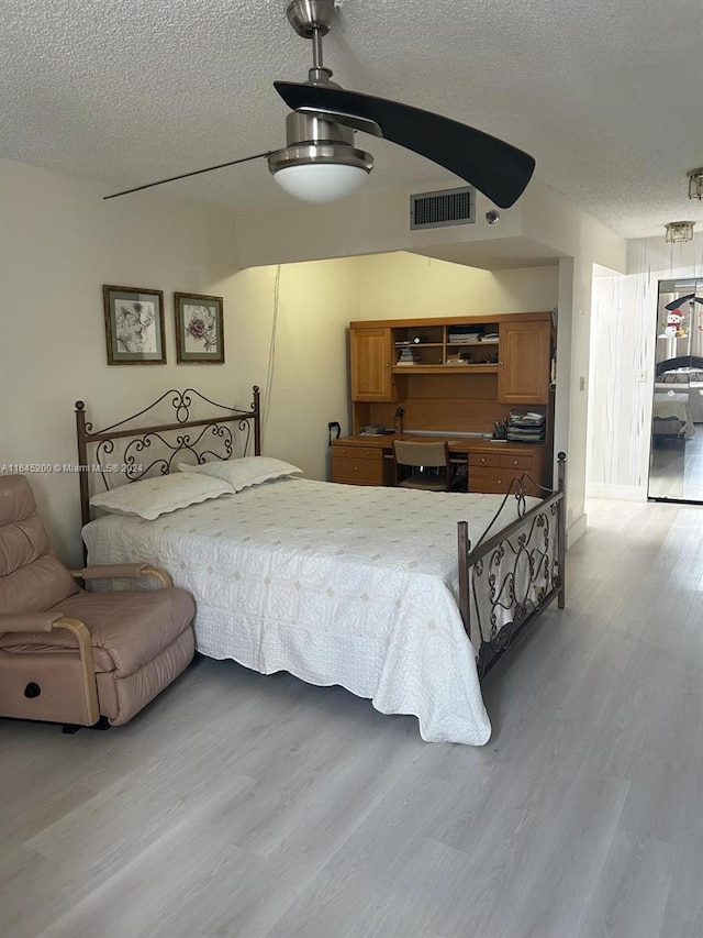 900 Saint Charles Pl Unit 316, Pembroke Pines, FL 33026 - bedroom featuring a textured ceiling, light wood-type flooring, and a ceiling fan
