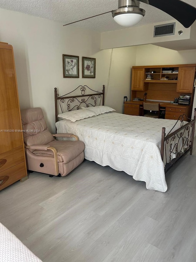 900 Saint Charles Pl Unit 316, Pembroke Pines, FL 33026 - bedroom with light wood-style flooring and a textured ceiling