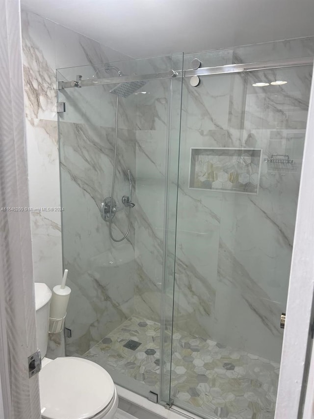 900 Saint Charles Pl Unit 316, Pembroke Pines, FL 33026 - bathroom featuring toilet and a marble finish shower