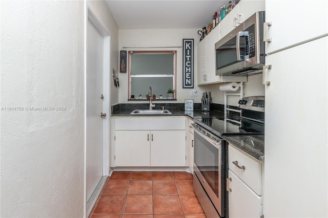 kitchen with sink, white cabinetry, tile patterned floors, and appliances with stainless steel finishes