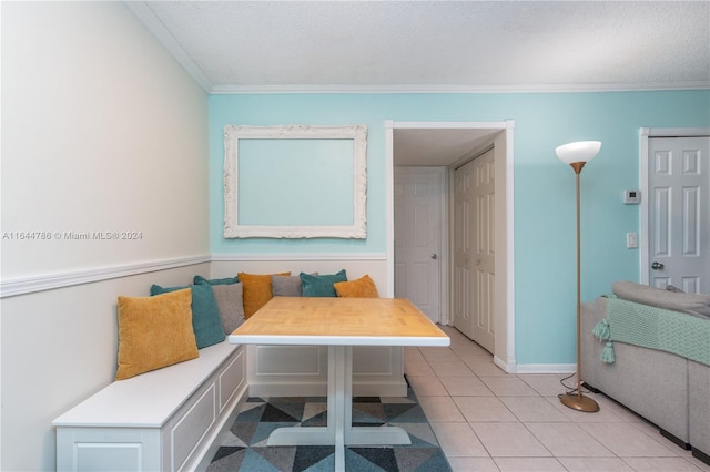 bathroom featuring breakfast area, ornamental molding, a textured ceiling, and tile patterned floors