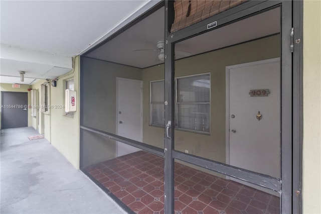 view of exterior entry featuring ceiling fan