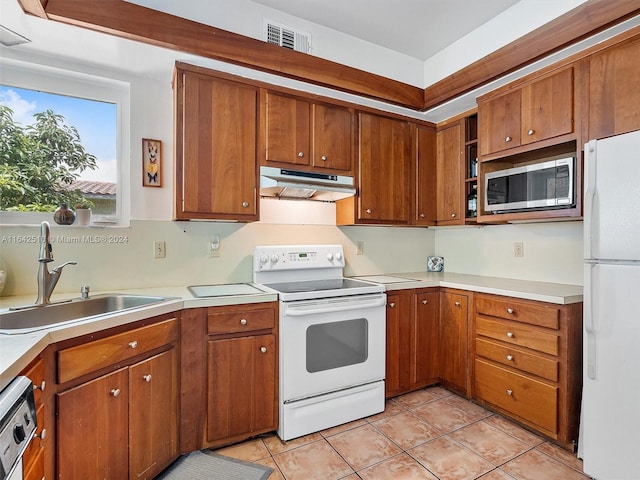 kitchen with sink, light tile patterned floors, and appliances with stainless steel finishes