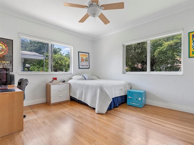 bedroom featuring light wood-type flooring, ceiling fan, and ornamental molding