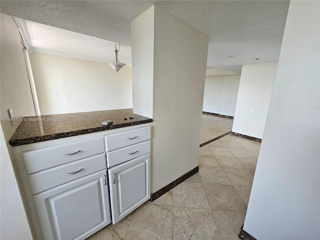 1650 Coral Way Unit 601, Miami, FL 33145 - kitchen featuring a textured ceiling and white cabinetry