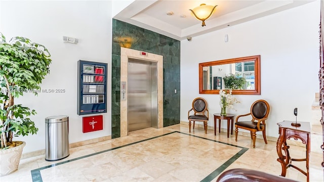 1650 Coral Way Unit 601, Miami, FL 33145 - entrance foyer featuring inlaid floor details, marble tiled flooring, elevator, and a high ceiling