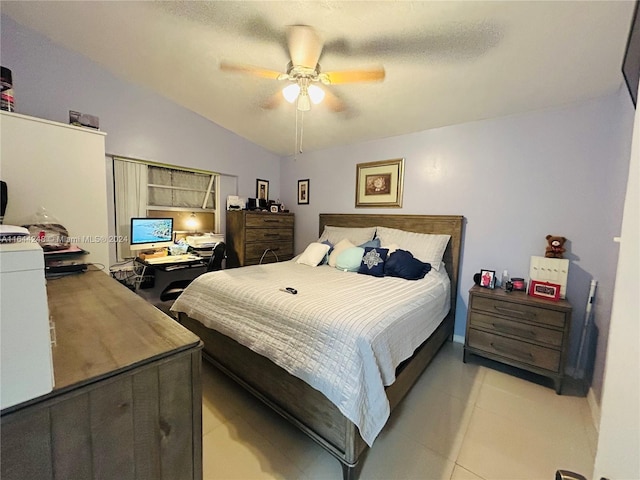 tiled bedroom with ceiling fan and lofted ceiling