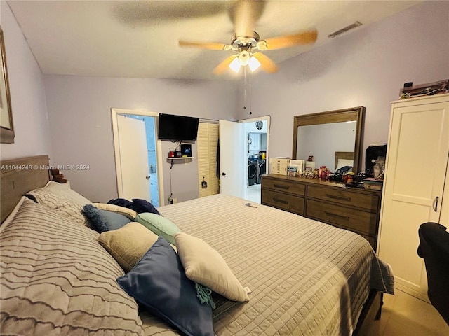 bedroom featuring ceiling fan, ensuite bath, and vaulted ceiling