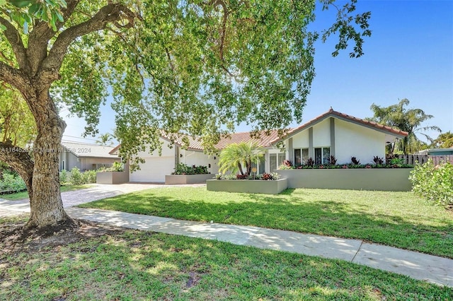 view of front of property featuring a garage and a front yard