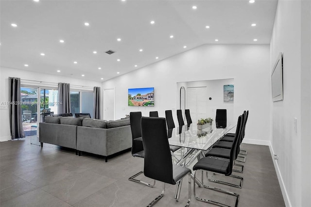 tiled dining room with high vaulted ceiling