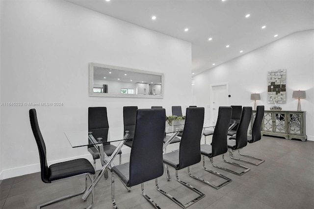 dining space featuring high vaulted ceiling