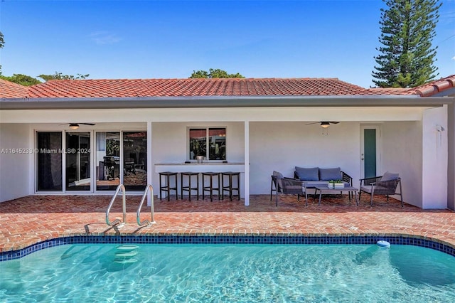 view of pool with ceiling fan, a patio, and an outdoor hangout area