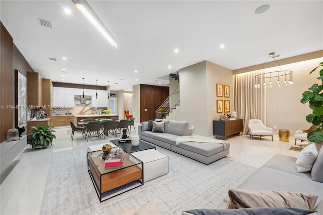 tiled living room with a chandelier