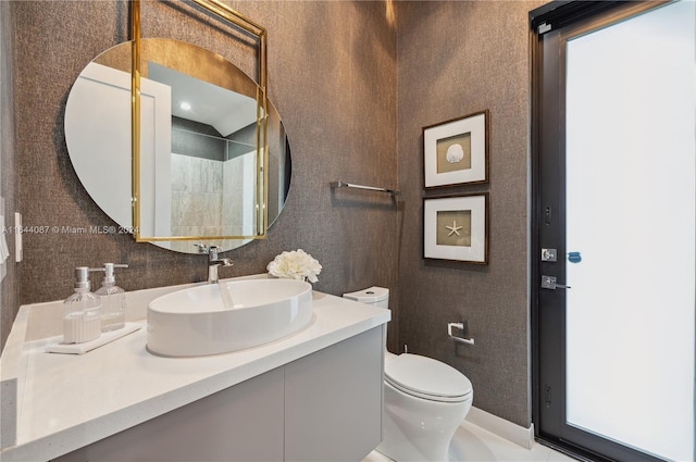 bathroom with toilet and vanity