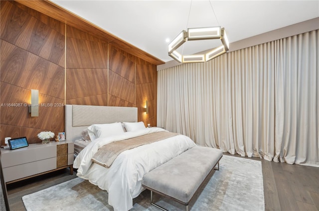 bedroom featuring wood walls and wood-type flooring