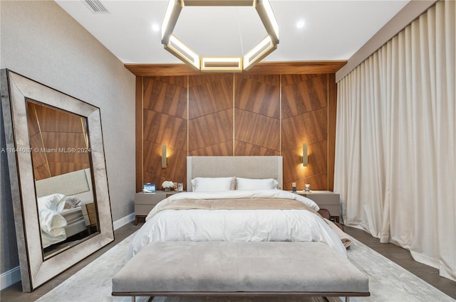 bedroom featuring wooden walls