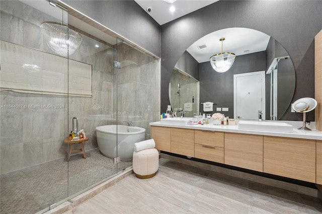 bathroom with shower with separate bathtub, double sink vanity, and tile patterned flooring