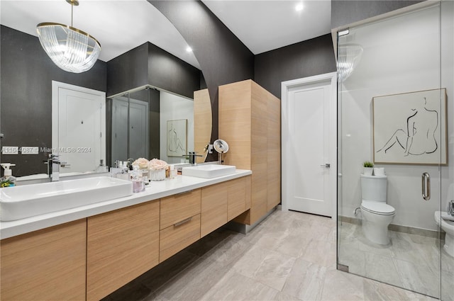 bathroom with tile patterned floors, double vanity, a bidet, and toilet