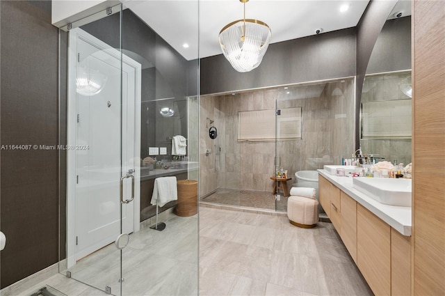 bathroom featuring tile patterned floors, a bidet, a shower with door, and vanity