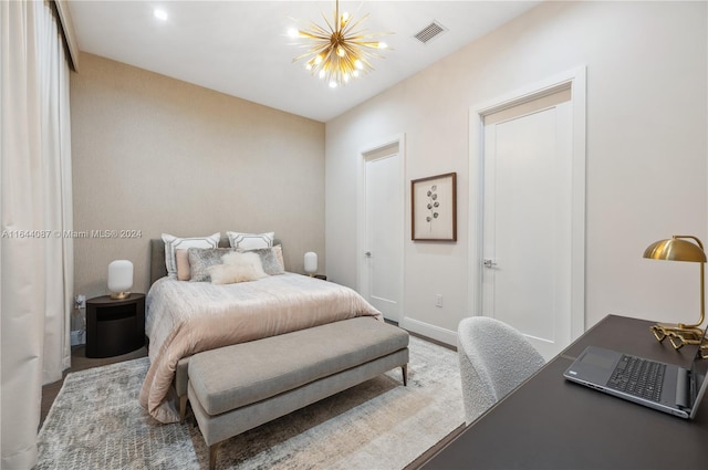 bedroom with an inviting chandelier and wood-type flooring