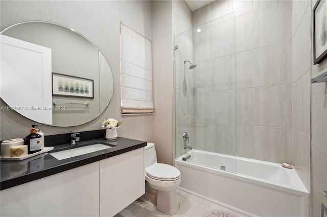 full bathroom featuring tiled shower / bath combo, toilet, tile patterned floors, and vanity