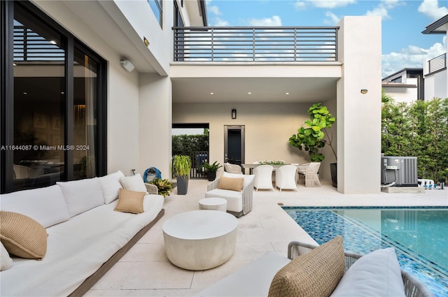 view of pool with an outdoor living space and a patio area