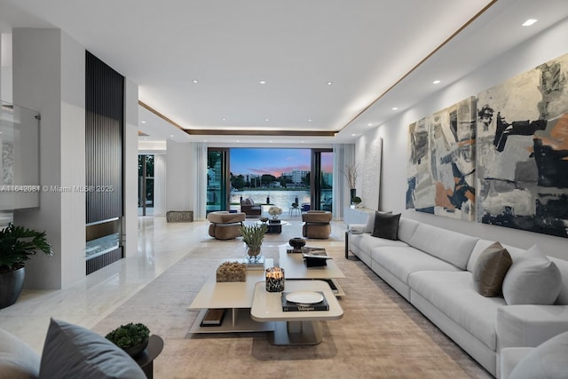 living room with a tray ceiling and expansive windows