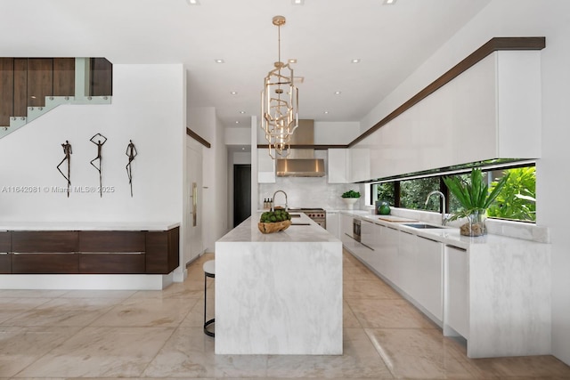 kitchen with dark brown cabinetry, white cabinetry, a center island, sink, and pendant lighting