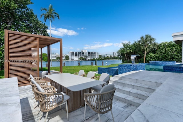 view of patio with a swimming pool with hot tub, a water view, and an outdoor bar