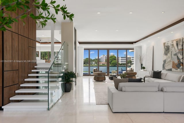 tiled living room featuring a water view