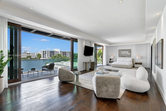 living room featuring expansive windows and dark hardwood / wood-style flooring