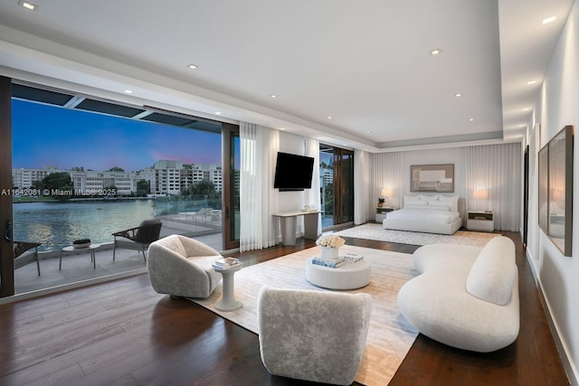 bedroom with expansive windows and wood-type flooring