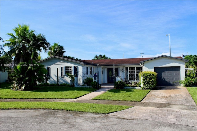 single story home featuring a front yard and a garage