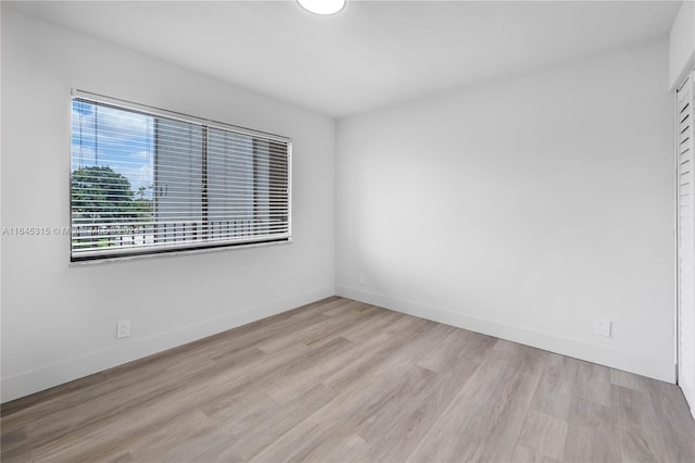 spare room featuring light wood-type flooring