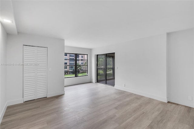 spare room featuring light wood-type flooring