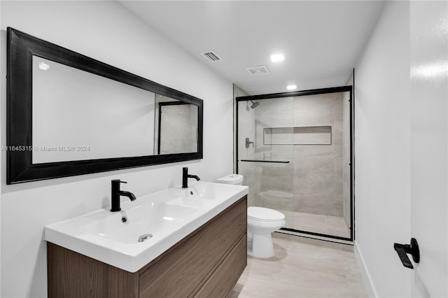 bathroom featuring tile patterned flooring, an enclosed shower, vanity, and toilet