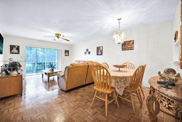 4800 Hillcrest Ln Unit 210, Hollywood, FL 33021 - dining space with a textured ceiling, ceiling fan, and a chandelier