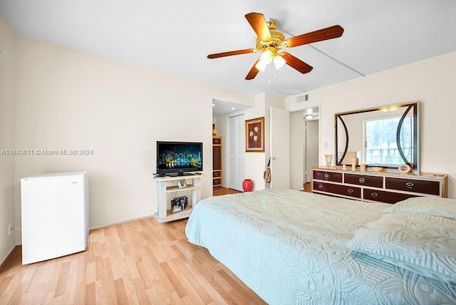 4800 Hillcrest Ln Unit 210, Hollywood, FL 33021 - bedroom with light wood-style flooring, baseboards, ceiling fan, and refrigerator