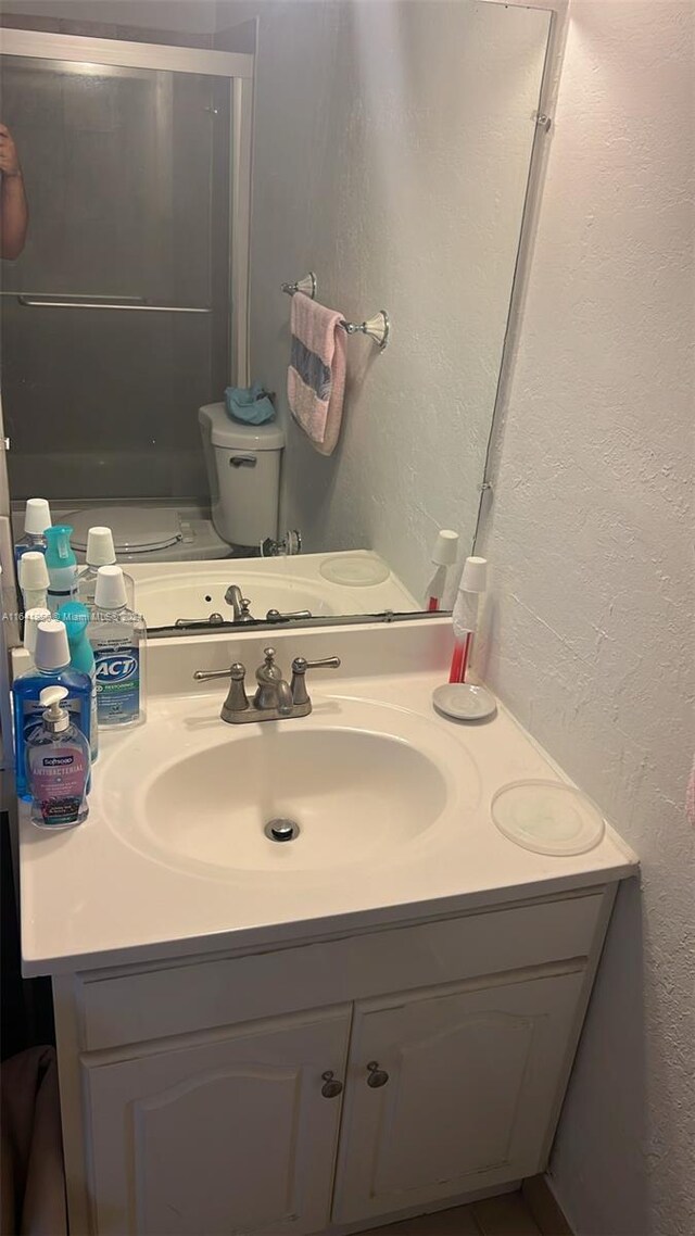 bathroom featuring toilet and vanity