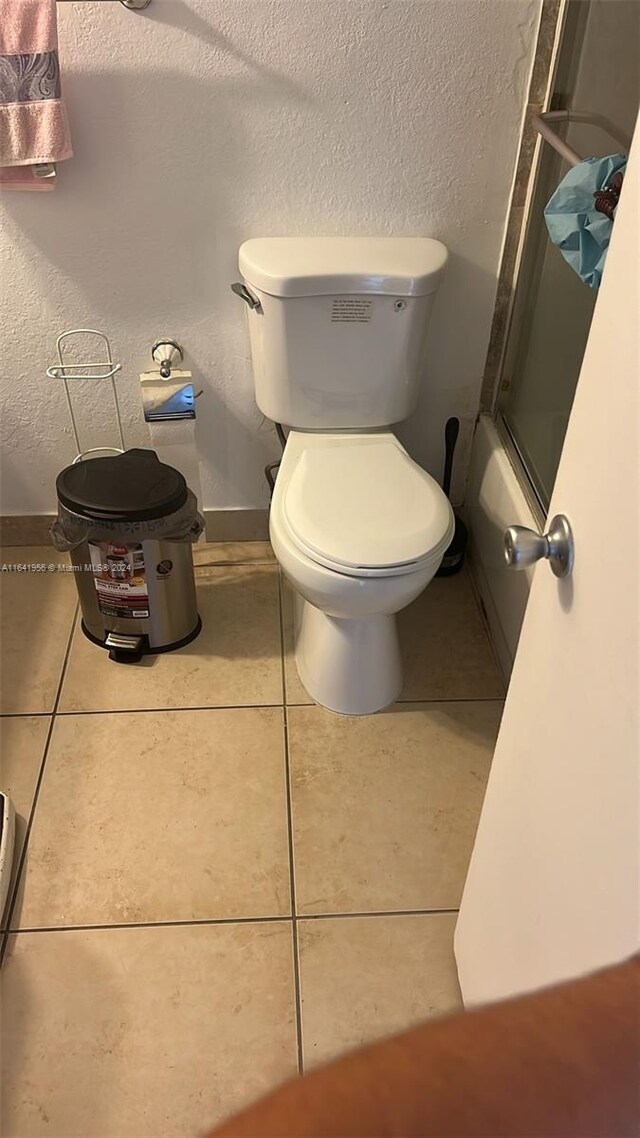 bathroom with tile patterned flooring and toilet