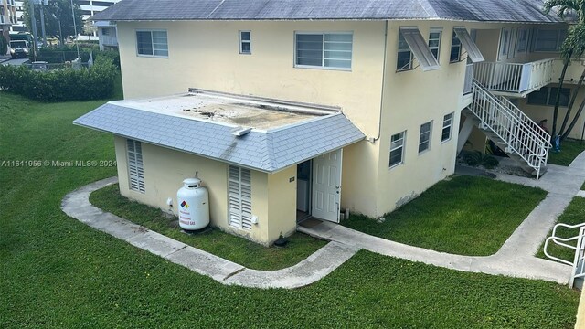 rear view of house with a yard