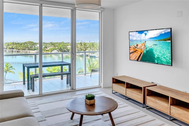 living area with expansive windows and a water view