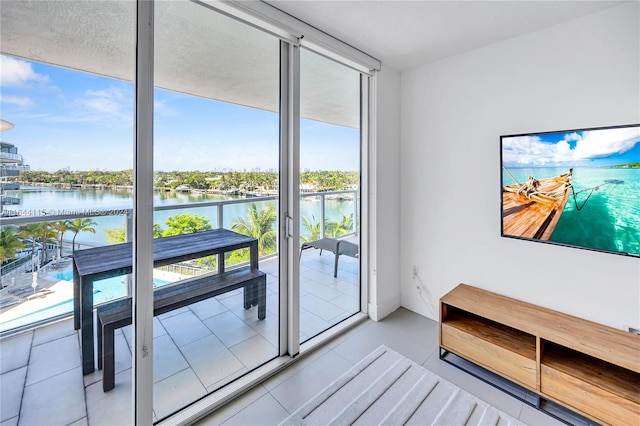 interior space featuring a wall of windows and a water view