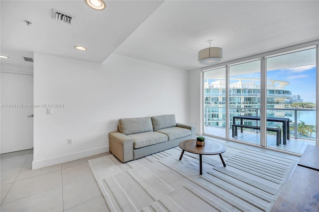 living room featuring floor to ceiling windows and light tile patterned floors