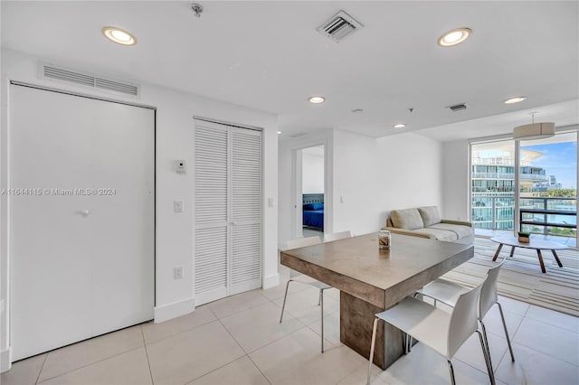 dining area with light tile patterned flooring and expansive windows